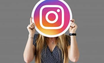 woman showing instagram icon
