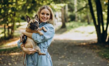 young woman with her pet french bulldog park