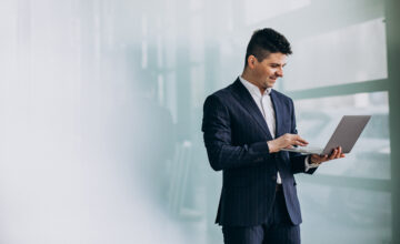 young handsome business man with laptop office