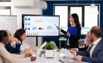 young team leader big corporation briefing coworkers pointing graph meeting corporate staff