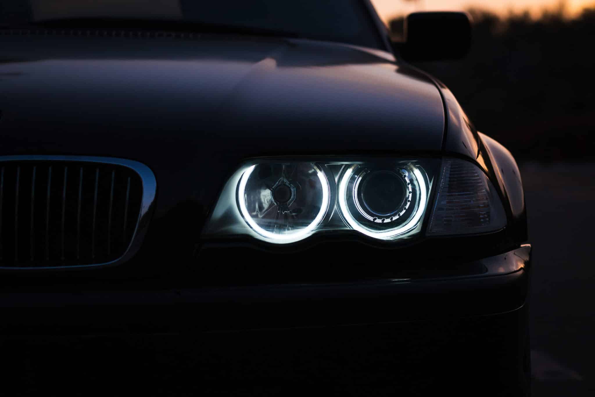 silhouette black sports car with headlights black background scaled