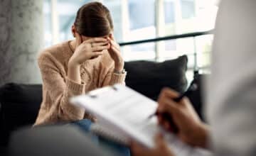 depressed woman having psychotherapy session doctor s office