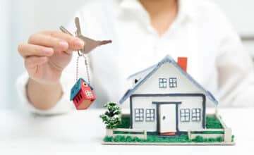 real estate agent with house model keys