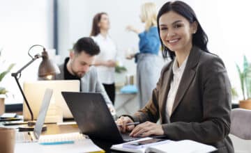 medium shot woman working laptop