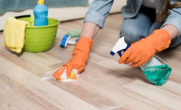 woman with rubber gloves cleaning floors