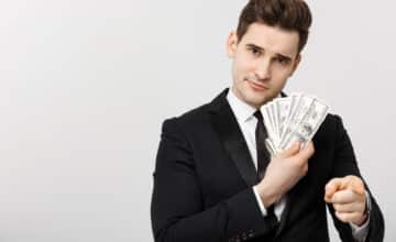 portrait businessman showing money pointing fingers isolated white background