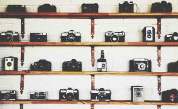 cameras on shelves PHOTOGRAPHY0822 7d3ddad95d304b7ca9457a04da54100e