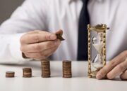 front view businessman with coins hourglass 1