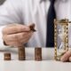 front view businessman with coins hourglass 1